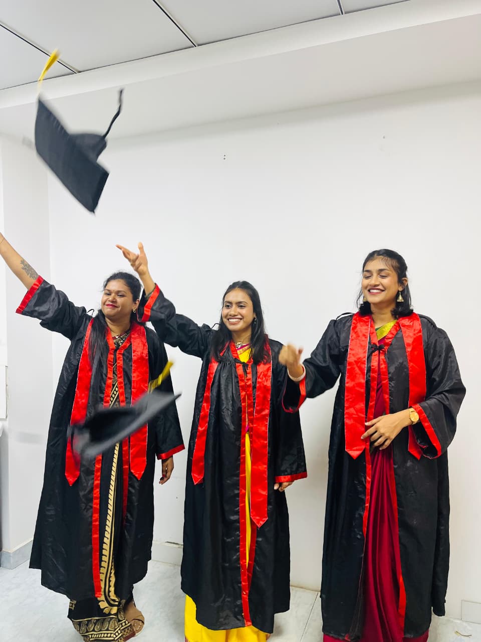 Mom & Me fellowship graduates tossing their caps